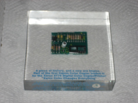 Glass Case Containing the Motherboard of a Competitve Replacement